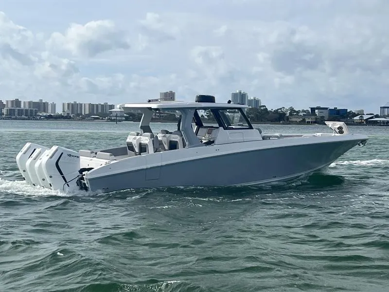 The Image of 2024 Fountain 38 SCX boat cruising on water with city skyline in background. - 0