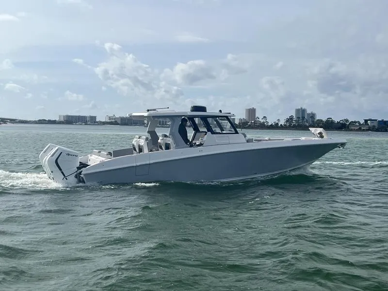 Slide: The Image of 2024 Fountain 38 SCX boat cruising on water with city skyline in background. - 1