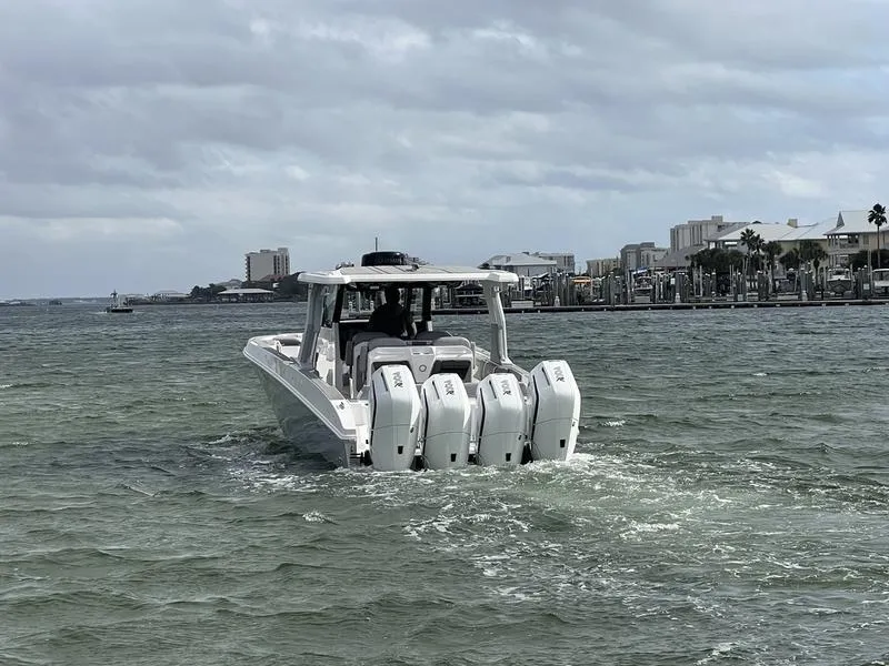 Slide: The Image of 2024 Fountain 38 SCX boat with four outboard engines cruising on a cloudy day. - 11