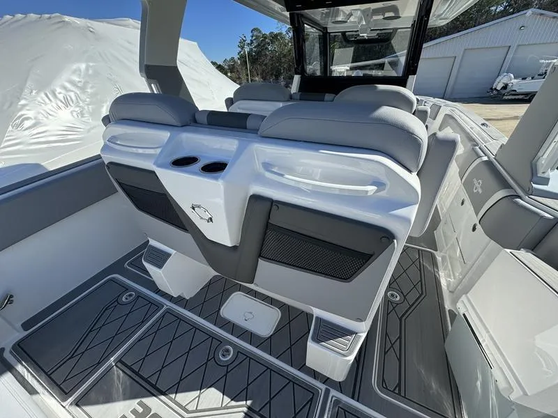 Slide: The Image of 2024 Fountain 38 SCX boat interior with cushioned seating and cup holders. - 13