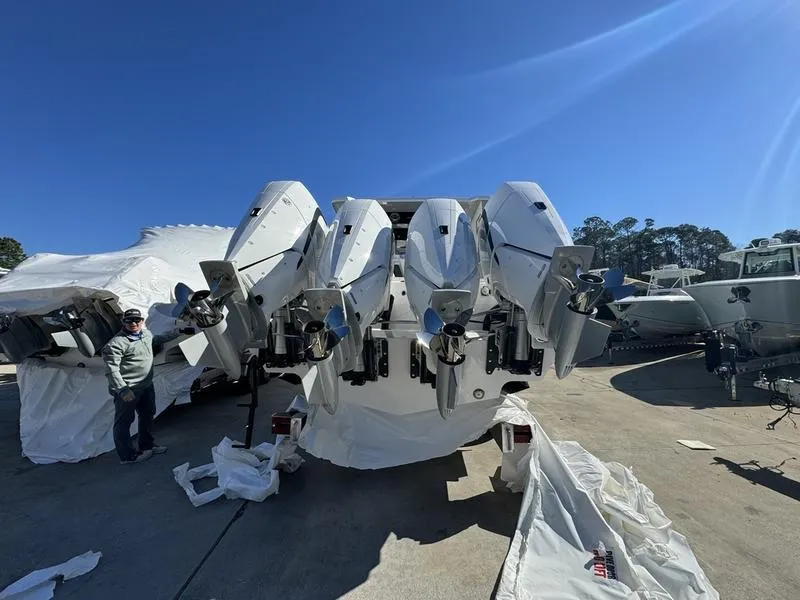 Slide: The Image of 2024 Fountain 38 SCX boat with multiple outboard engines in a marina. - 4