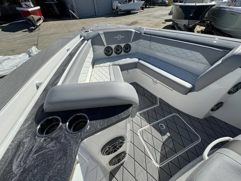 Slide: The Image of 2024 Fountain 38 SCX boat interior with cushioned seating and cup holders. - 7