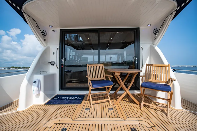 Slide: The Image of 2007 Maritimo Enclosed Fly Bridge yacht with wooden deck and outdoor seating. - 18