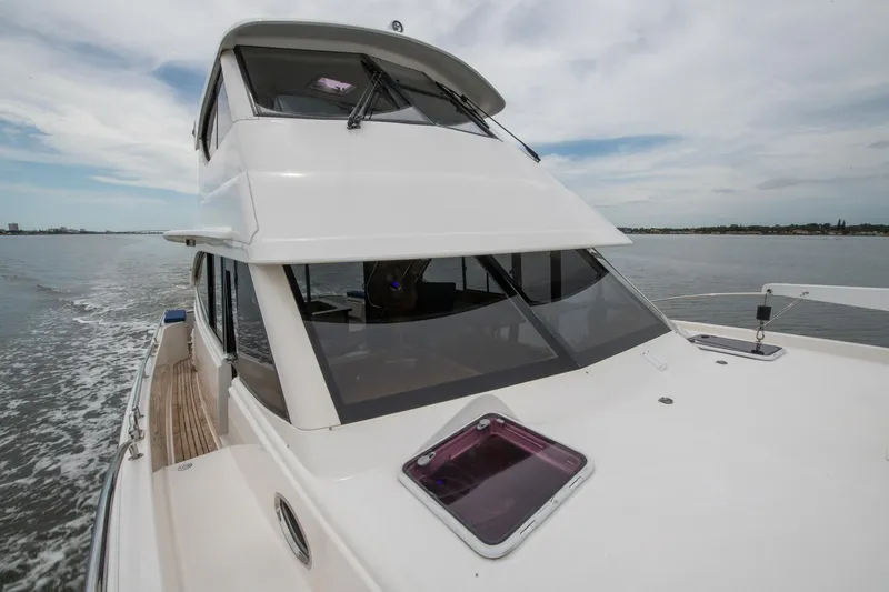 Slide: The Image of 2007 Maritimo Enclosed Fly Bridge yacht on calm waters, side deck view. - 24