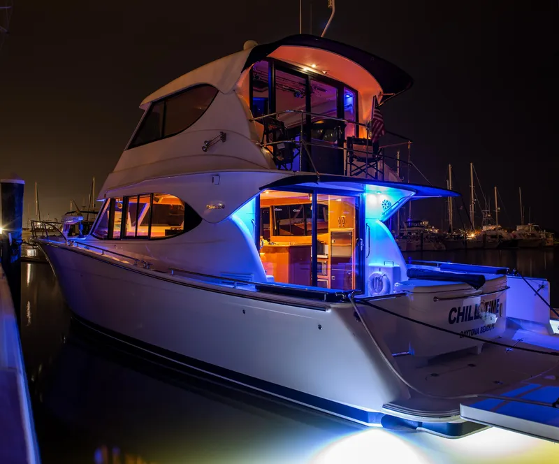 Slide: The Image of 2007 Maritimo Enclosed Fly Bridge yacht at night with scenic water view. - 32