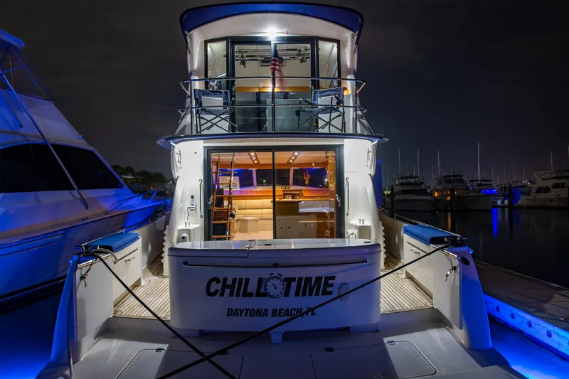 Slide: The Image of 2007 Maritimo Enclosed Fly Bridge yacht illuminated at night in a marina. - 33