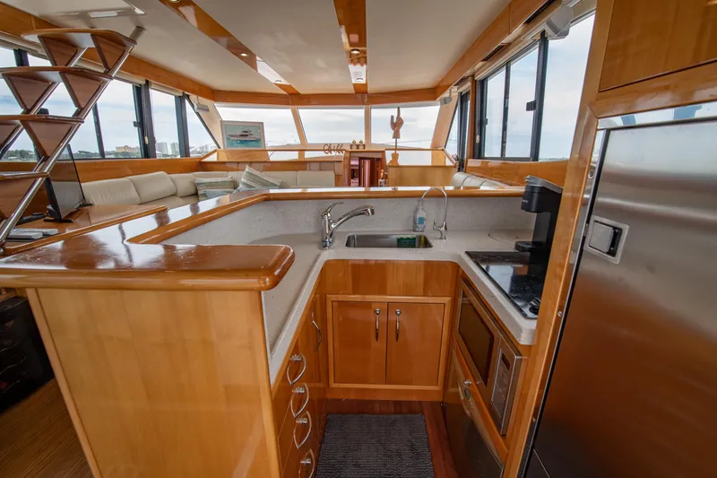 Slide: The Image of 2007 Maritimo Enclosed Fly Bridge interior with modern kitchen and panoramic windows. - 44