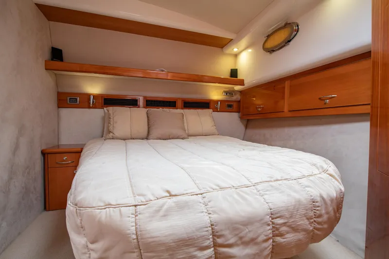 Slide: The Image of Luxurious bedroom in 2007 Maritimo Enclosed Fly Bridge yacht with cozy bedding. - 45