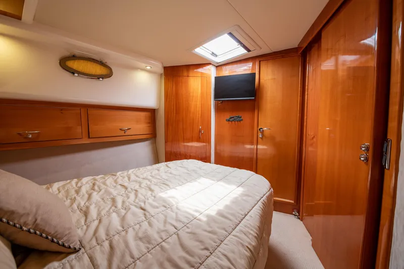 Slide: The Image of Luxurious bedroom interior of 2007 Maritimo Enclosed Fly Bridge yacht with wood finishes. - 47