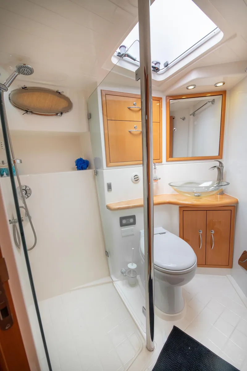 Slide: The Image of 2007 Maritimo Enclosed Fly Bridge bathroom with modern fixtures and skylight. - 49