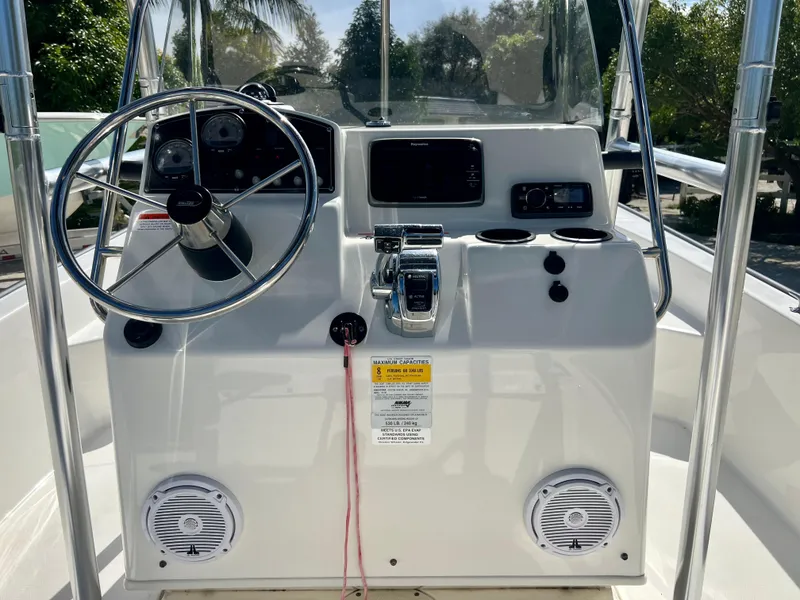 Slide: The Image of 2013 Boston Whaler MONTAUK boat console with steering wheel and controls. - 12