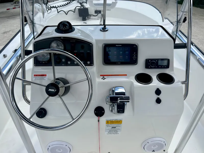 Slide: The Image of 2013 Boston Whaler MONTAUK boat console with steering wheel, gauges, and navigation system. - 13