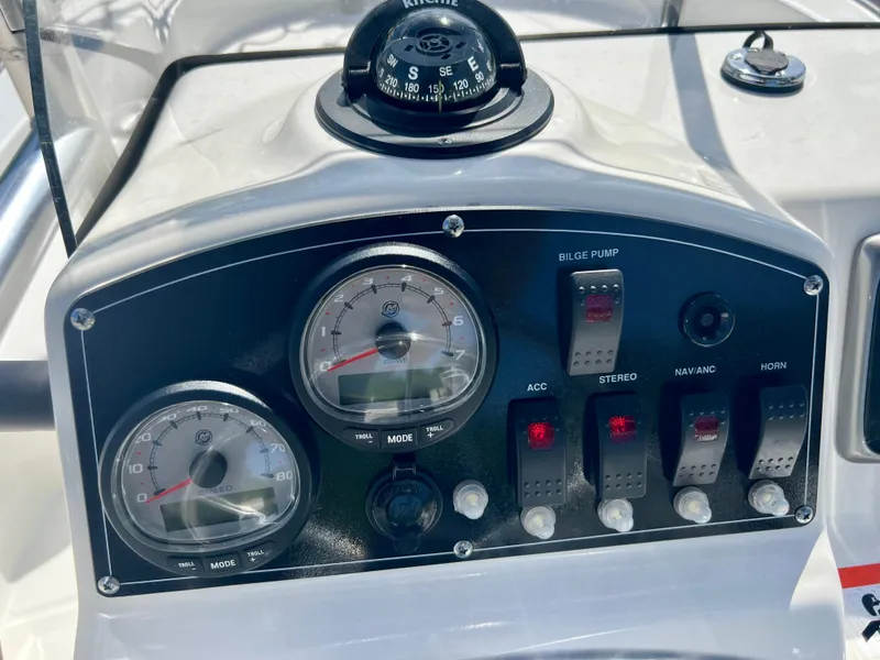 Slide: The Image of Control panel of a 2013 Boston Whaler MONTAUK boat with gauges and switches. - 15