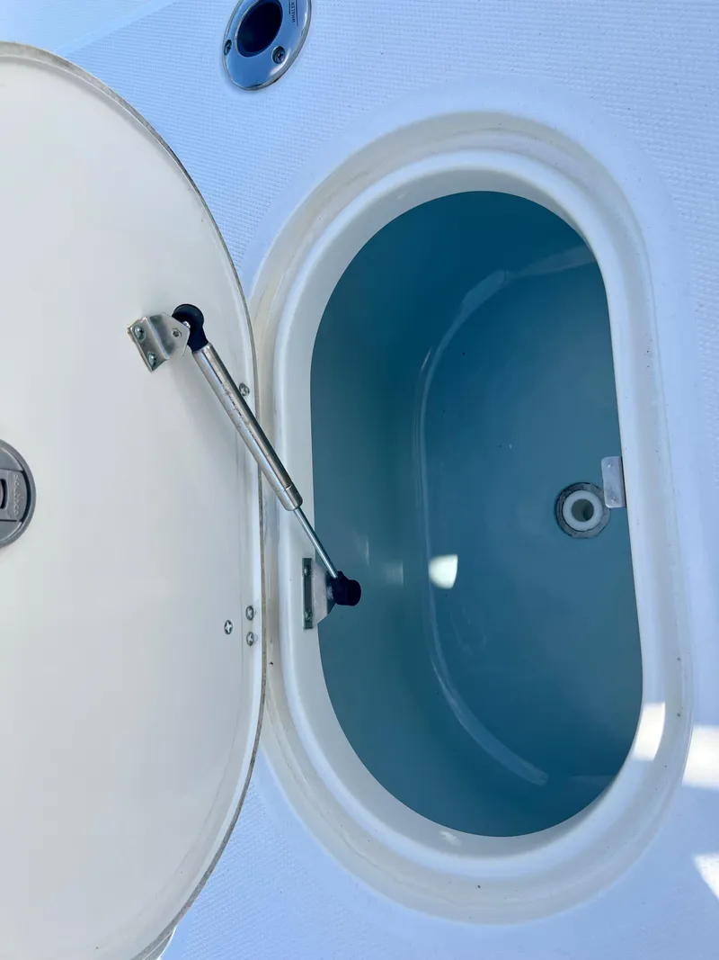 Slide: The Image of Open storage compartment on a 2013 Boston Whaler MONTAUK boat. - 22