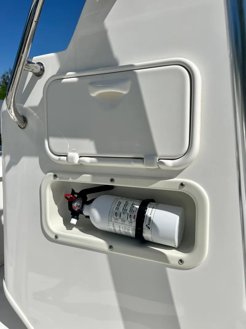 Slide: The Image of Fire extinguisher compartment on a 2013 Boston Whaler MONTAUK boat. - 26
