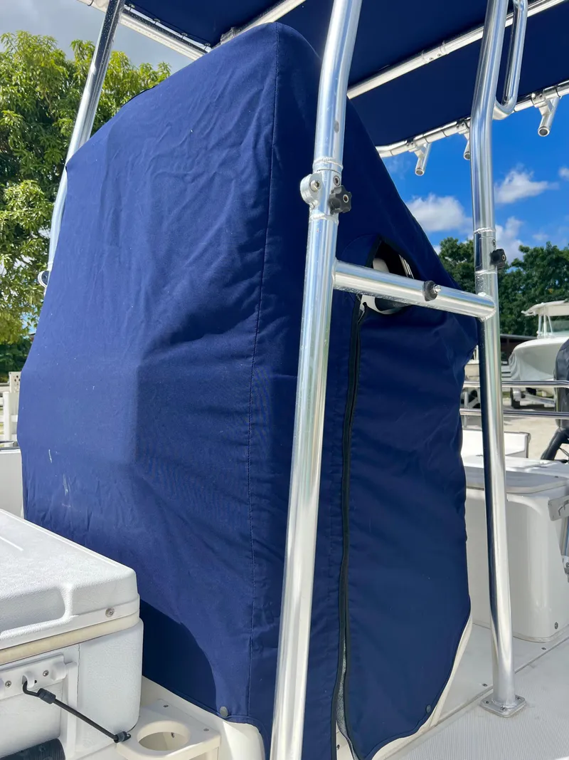 Slide: The Image of 2013 Boston Whaler MONTAUK boat with blue console cover and stainless steel frame. - 33