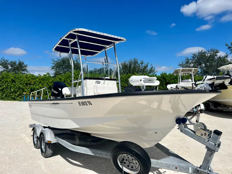 Slide: The Image of 2013 Boston Whaler MONTAUK boat on a trailer under a clear blue sky. - 7