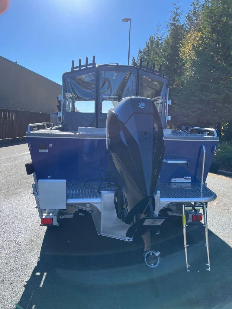 Slide: The Image of 2024 Spartan 215 Athens boat with outboard motor, rear view. - 12