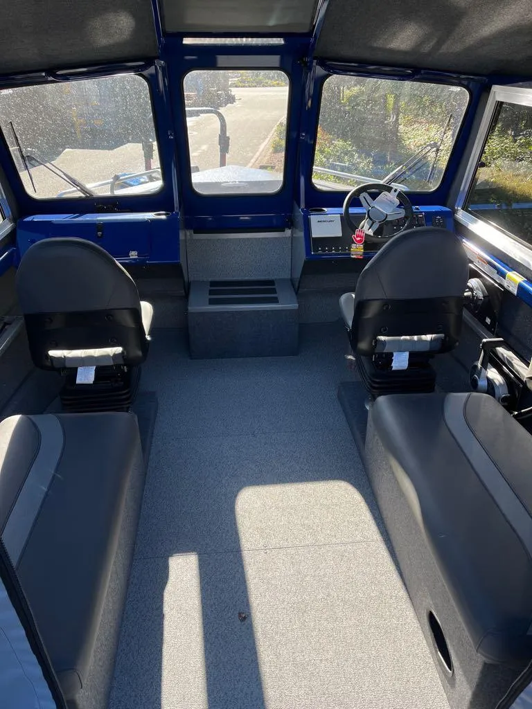 Slide: The Image of 2024 Spartan 215 Athens boat interior with dual seats and steering console. - 14