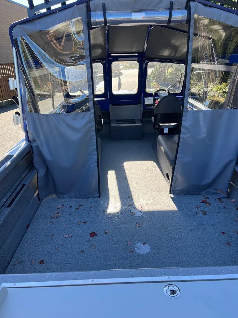 Slide: The Image of 2024 Spartan 215 Athens boat interior with seating and steering console. - 15