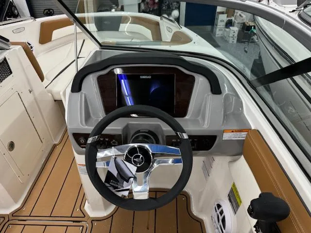 Slide: The Image of 2024 Chaparral 21 SSi boat dashboard with steering wheel and navigation display. - 10