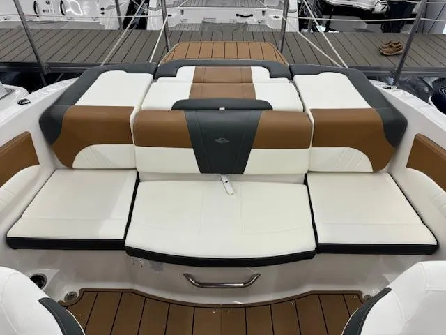 Slide: The Image of 2024 Chaparral 21 SSi boat with stylish brown and white seating. - 13