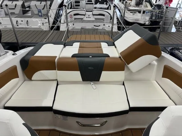 Slide: The Image of 2024 Chaparral 21 SSi boat interior with white and brown seating. - 14