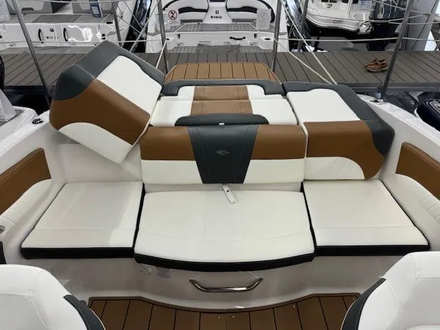 Slide: The Image of 2024 Chaparral 21 SSi boat interior with brown and white seating. - 15