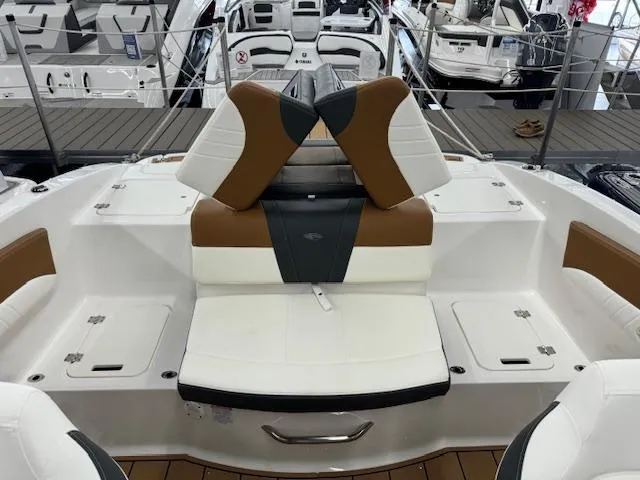 Slide: The Image of 2024 Chaparral 21 SSi boat interior with white and brown seating. - 16