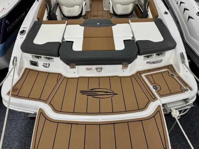 Slide: The Image of 2024 Chaparral 21 SSi boat interior with tan and white seating and deck. - 18