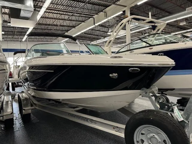 Slide: The Image of 2024 Chaparral 21 SSi boat on a trailer in a showroom. - 2
