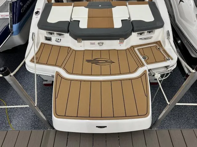 Slide: The Image of 2024 Chaparral 21 SSi boat with teak-style swim platform and cushioned seating. - 20