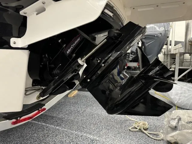 Slide: The Image of 2024 Chaparral 21 SSi boat with MerCruiser outdrive in a showroom. - 21