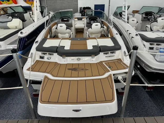 Slide: The Image of 2024 Chaparral 21 SSi boat with tan and white interior, displayed in a showroom. - 4