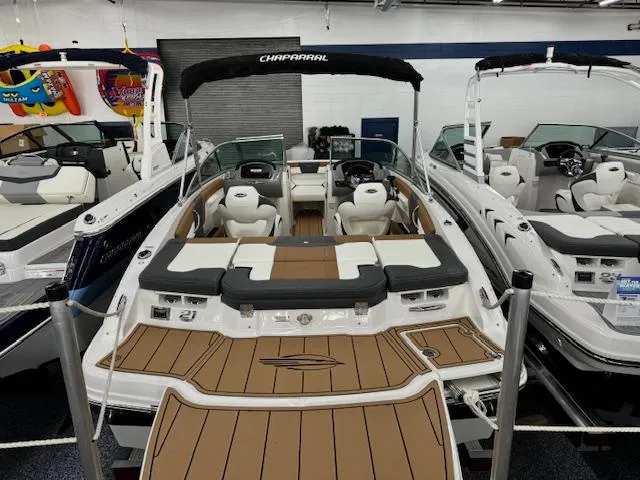 Slide: The Image of 2024 Chaparral 21 SSi boat with tan and white interior, displayed in showroom. - 5
