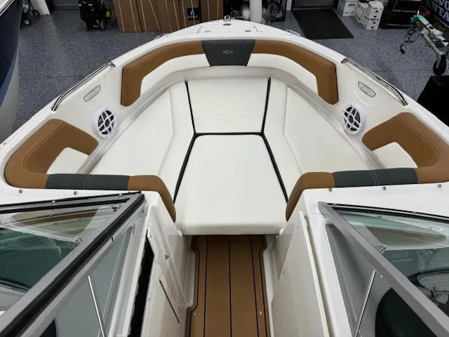 Slide: The Image of 2024 Chaparral 21 SSi boat interior with white and brown seating. - 6