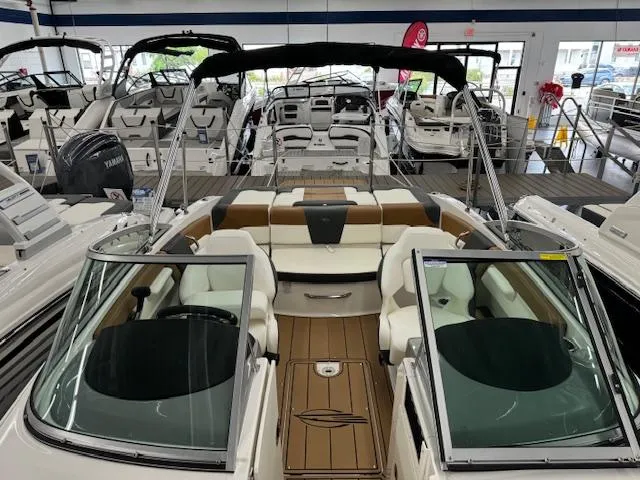 Slide: The Image of 2024 Chaparral 21 SSi boat interior with seating and windshield in showroom. - 8