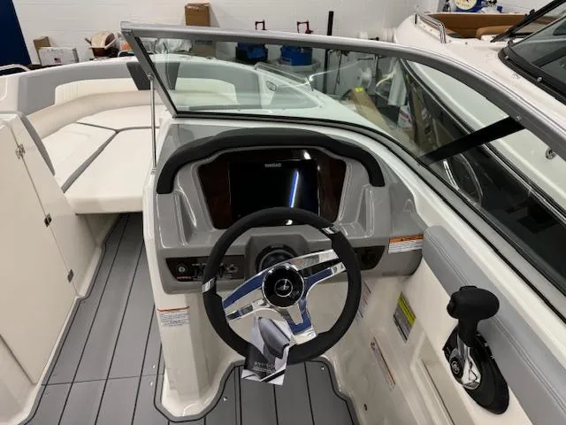 Slide: The Image of 2024 Chaparral 23 SSi boat cockpit with steering wheel and dashboard. - 10