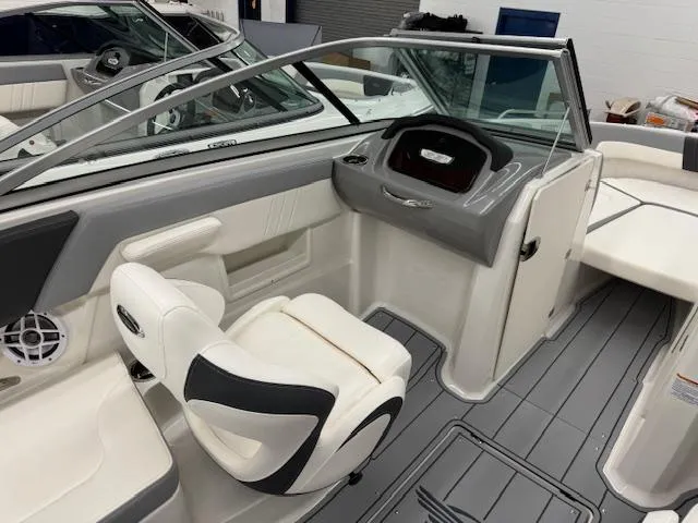 Slide: The Image of 2024 Chaparral 23 SSi boat interior with helm and seating area. - 11