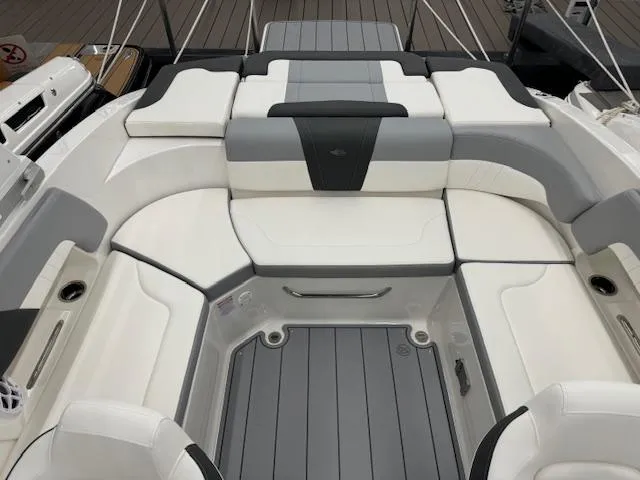 Slide: The Image of 2024 Chaparral 23 SSi boat interior with white and gray seating. - 13