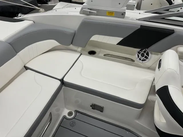 Slide: The Image of 2024 Chaparral 23 SSi boat interior with white and gray seating. - 14