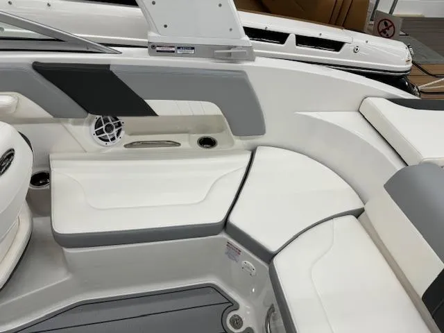 Slide: The Image of 2024 Chaparral 23 SSi boat interior seating area with white and gray upholstery. - 16