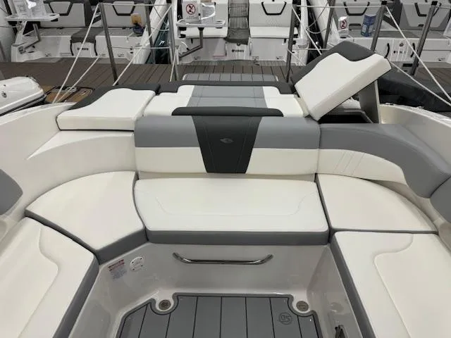 Slide: The Image of 2024 Chaparral 23 SSi boat interior with white and gray seating. - 17