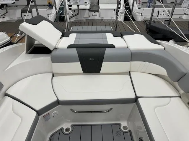 Slide: The Image of 2024 Chaparral 23 SSi boat interior seating with white and gray upholstery. - 18