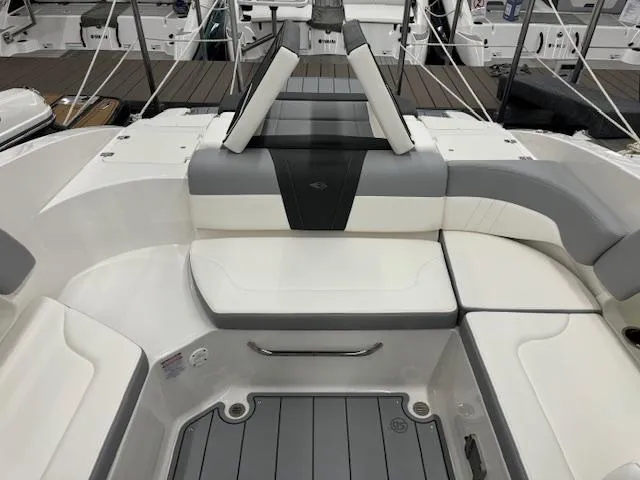 Slide: The Image of 2024 Chaparral 23 SSi boat interior with white and gray seating. - 19