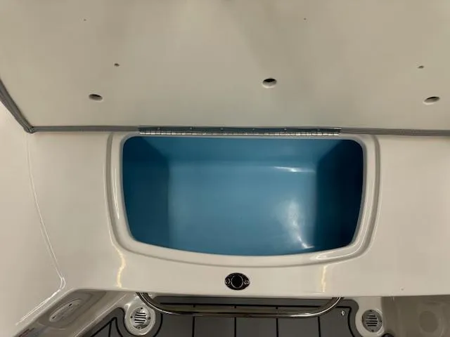 Slide: The Image of 2024 Chaparral 23 SSi boat storage compartment with blue interior. - 22
