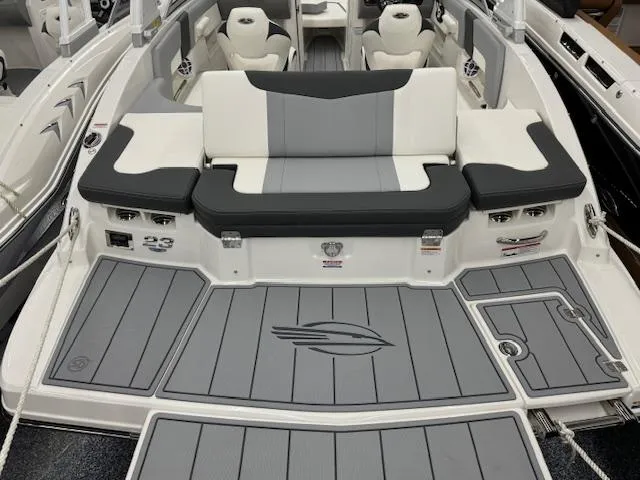 Slide: The Image of 2024 Chaparral 23 SSi boat interior with gray and white seating and deck. - 23