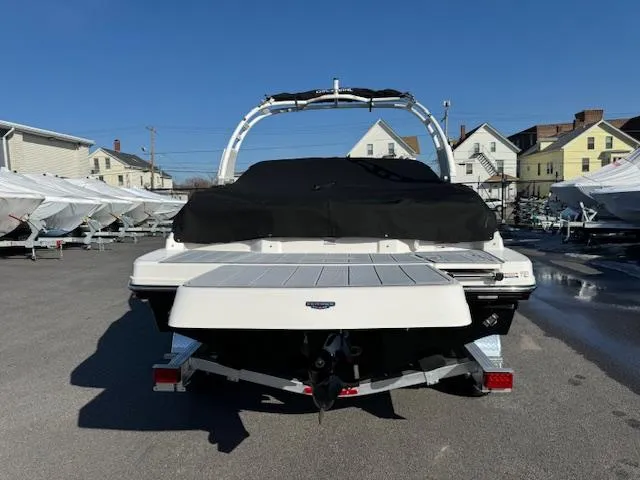 Slide: The Image of 2024 Chaparral 23 SSi boat, rear view, in a marina parking lot. - 28