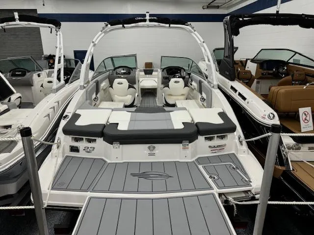 Slide: The Image of 2024 Chaparral 23 SSi boat with spacious seating and modern design in showroom. - 5