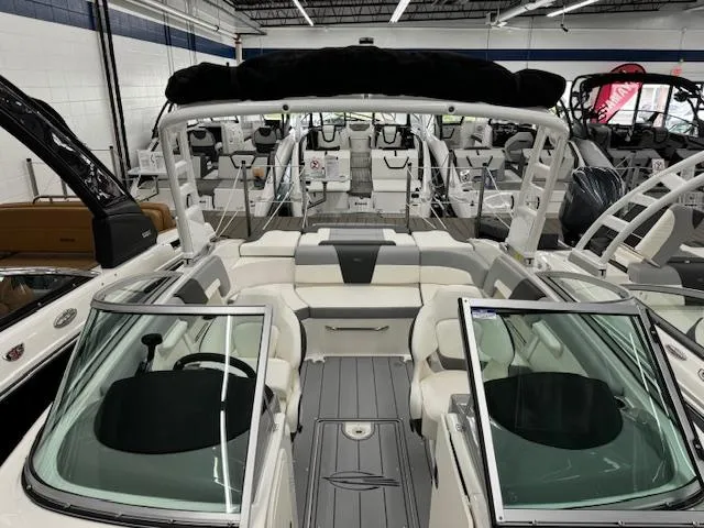 Slide: The Image of 2024 Chaparral 23 SSi boat interior with seating and windshield in showroom. - 8